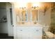 Bathroom with a double sink vanity, framed mirrors, and updated lighting fixtures at 11123 Waxberry Dr, Charlotte, NC 29277