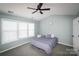 Bedroom featuring a ceiling fan, large window, and comfortable bedding at 11123 Waxberry Dr, Charlotte, NC 29277
