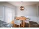 Dining area featuring a wooden table and four chairs beneath a modern light fixture at 11123 Waxberry Dr, Charlotte, NC 29277