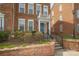 Inviting townhome entrance with brick steps, iron railing, and well-maintained landscaping at 11123 Waxberry Dr, Charlotte, NC 29277