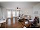Spacious living room features hardwood floors, large windows, and a cozy fireplace at 11123 Waxberry Dr, Charlotte, NC 29277