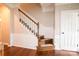 Elegant staircase with hardwood floors, white wainscoting, and a classic design at 11123 Waxberry Dr, Charlotte, NC 29277