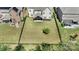 Aerial view of backyard, showing the landscaping, covered patio, lawn and fence at 11313 Limehurst Pl, Charlotte, NC 28278