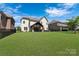 Expansive backyard featuring a covered patio and lush green lawn, perfect for outdoor activities at 11313 Limehurst Pl, Charlotte, NC 28278