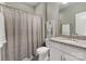 Bright bathroom with granite countertop, white cabinets, decorative art, and shower with curtain at 11313 Limehurst Pl, Charlotte, NC 28278