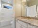 Bathroom featuring granite countertops, white cabinets, and a bright, airy feel with natural light at 11313 Limehurst Pl, Charlotte, NC 28278