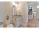Stylish half bath features a granite vanity and updated fixtures at 11313 Limehurst Pl, Charlotte, NC 28278