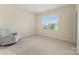 Bright and airy bedroom with a rocking chair, large window, and neutral decor creating a tranquil retreat at 11313 Limehurst Pl, Charlotte, NC 28278