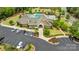 Aerial view of a clubhouse with a pool, playground, and parking lot, surrounded by trees and landscaping at 11313 Limehurst Pl, Charlotte, NC 28278