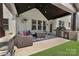 Outdoor living space with comfortable seating, grill, and dining area for relaxation and entertainment at 11313 Limehurst Pl, Charlotte, NC 28278