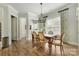 Charming dining room with hardwood floors, stylish chandelier, and plenty of natural light at 11313 Limehurst Pl, Charlotte, NC 28278
