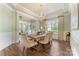 Bright dining room with hardwood floors, elegant chandelier, and natural light, perfect for Gathering gatherings at 11313 Limehurst Pl, Charlotte, NC 28278