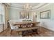 Elegant dining room with a chandelier, large wooden table, and stylish decor for entertaining guests at 11313 Limehurst Pl, Charlotte, NC 28278