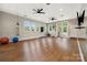 Bright gym featuring wood flooring, exercise equipment, windows with natural light, and ceiling fans at 11313 Limehurst Pl, Charlotte, NC 28278
