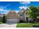 Beautiful two-story home with a stone and brick facade, well-maintained lawn, and inviting curb appeal at 11313 Limehurst Pl, Charlotte, NC 28278