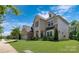 Charming home featuring stone accents, a well-groomed lawn, and lush landscaping at 11313 Limehurst Pl, Charlotte, NC 28278