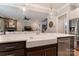 Open-concept kitchen with stainless appliances, farmhouse sink, and views into the Gathering room at 11313 Limehurst Pl, Charlotte, NC 28278
