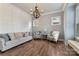 Comfortable living room with hardwood floors, neutral paint and furniture, and natural light from two windows at 11313 Limehurst Pl, Charlotte, NC 28278