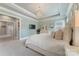 Spacious main bedroom with trey ceiling, elegant chandelier, decorative mirror, and tranquil color palette at 11313 Limehurst Pl, Charlotte, NC 28278