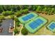 Aerial view of multiple tennis courts surrounded by trees and greenery at 11313 Limehurst Pl, Charlotte, NC 28278