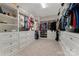Spacious walk-in closet with custom shelving, drawers, and ample storage space for clothes and accessories at 11313 Limehurst Pl, Charlotte, NC 28278