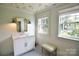 Charming bathroom with butterfly-themed wallpaper, a vanity with a marble countertop, and a large window at 1137 Queens W Rd, Charlotte, NC 28207