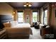Beautiful primary bedroom with natural light, decorative ceiling and accent chairs at 1137 Queens W Rd, Charlotte, NC 28207