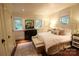 Comfortable bedroom with a plush bed, decorative pillows, and ample natural light from multiple windows at 1137 Queens W Rd, Charlotte, NC 28207