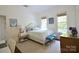 Bright bedroom featuring 2 large windows, hardwood floors, and comfortable furnishings at 1137 Queens W Rd, Charlotte, NC 28207