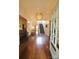Elegant foyer with dark wood floors, a decorative chandelier, and a staircase leading to the second floor at 1137 Queens W Rd, Charlotte, NC 28207