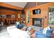 Relaxing living room boasts wood paneling, fireplace, comfortable seating, and entertainment setup at 1137 Queens W Rd, Charlotte, NC 28207
