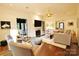 Cozy living room with a fireplace, comfortable seating, and a television, perfect for relaxation at 1137 Queens W Rd, Charlotte, NC 28207