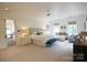 Spacious main bedroom with a king bed, sitting area, and large windows with natural light at 1137 Queens W Rd, Charlotte, NC 28207