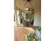 Charming covered patio with brick flooring, outdoor fireplace, ceiling fans and comfortable seating at 1137 Queens W Rd, Charlotte, NC 28207