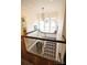 Staircase with light walls and dark wood trim leading to a seating nook with windows at 1137 Queens W Rd, Charlotte, NC 28207