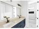 Elegant bathroom showcasing double sinks with gold fixtures, complemented by white and blue cabinets at 115 Augusta Ln, Shelby, NC 28150