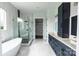 Spacious bathroom featuring a large frameless shower, blue cabinets, and a stand-alone tub at 115 Augusta Ln, Shelby, NC 28150