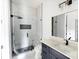 Bathroom featuring a frameless glass shower, granite countertops, black fixtures, and marble-look tile surround at 115 Augusta Ln, Shelby, NC 28150
