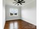Bright bedroom with hardwood floors and a view of the neighborhood through a large window at 115 Augusta Ln, Shelby, NC 28150