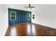 Bedroom featuring hardwood floors, a ceiling fan, and blue accent wall with board and batten at 115 Augusta Ln, Shelby, NC 28150