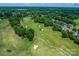Aerial view of golf course, showcasing lush fairways, sand traps, and nearby homes at 12002 Cobham Ct, Huntersville, NC 28078