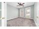 Bright bedroom with carpet, two windows, and neutral paint, offering a serene space at 12002 Cobham Ct, Huntersville, NC 28078