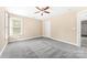 Bedroom featuring carpet, a light fixture, and a window allowing natural light at 12002 Cobham Ct, Huntersville, NC 28078