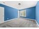 Bedroom featuring carpet, light-blue walls, a window, and a door at 12002 Cobham Ct, Huntersville, NC 28078