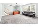 Bonus room with an adjacent staircase, a light fixture, a sofa, and a window at 12002 Cobham Ct, Huntersville, NC 28078