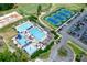 Aerial view showcasing neighborhood amenities; pools, tennis, golf, clubhouse and landscaping at 12002 Cobham Ct, Huntersville, NC 28078