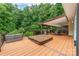 Spacious deck with covered seating, hot tub, and stainless steel grill, perfect for entertaining at 12002 Cobham Ct, Huntersville, NC 28078