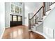 Grand foyer showcasing hardwood floors, a staircase with wooden railings, and a large front door with windows at 12002 Cobham Ct, Huntersville, NC 28078