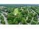 Aerial view of a lush golf course surrounded by mature trees and well-manicured lawns at 12002 Cobham Ct, Huntersville, NC 28078