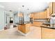 Open concept kitchen with island, stainless appliances, and tile flooring at 12002 Cobham Ct, Huntersville, NC 28078